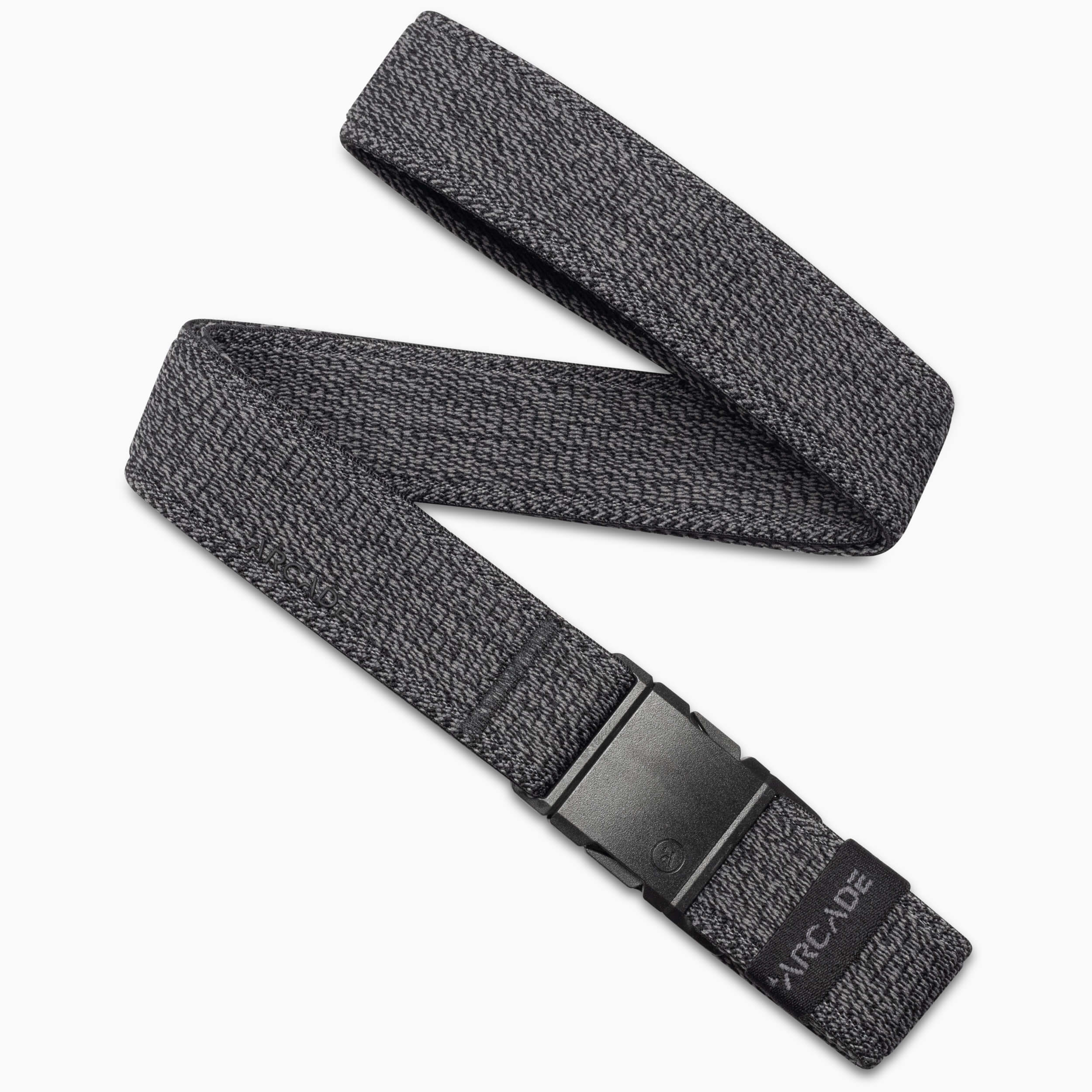 The Atlas by Arcade Belts is a gray woven elastic stretch belt with a subtle pattern and a black plastic buckle. Partially coiled on a white background, the ARCADE logo appears near the buckle.