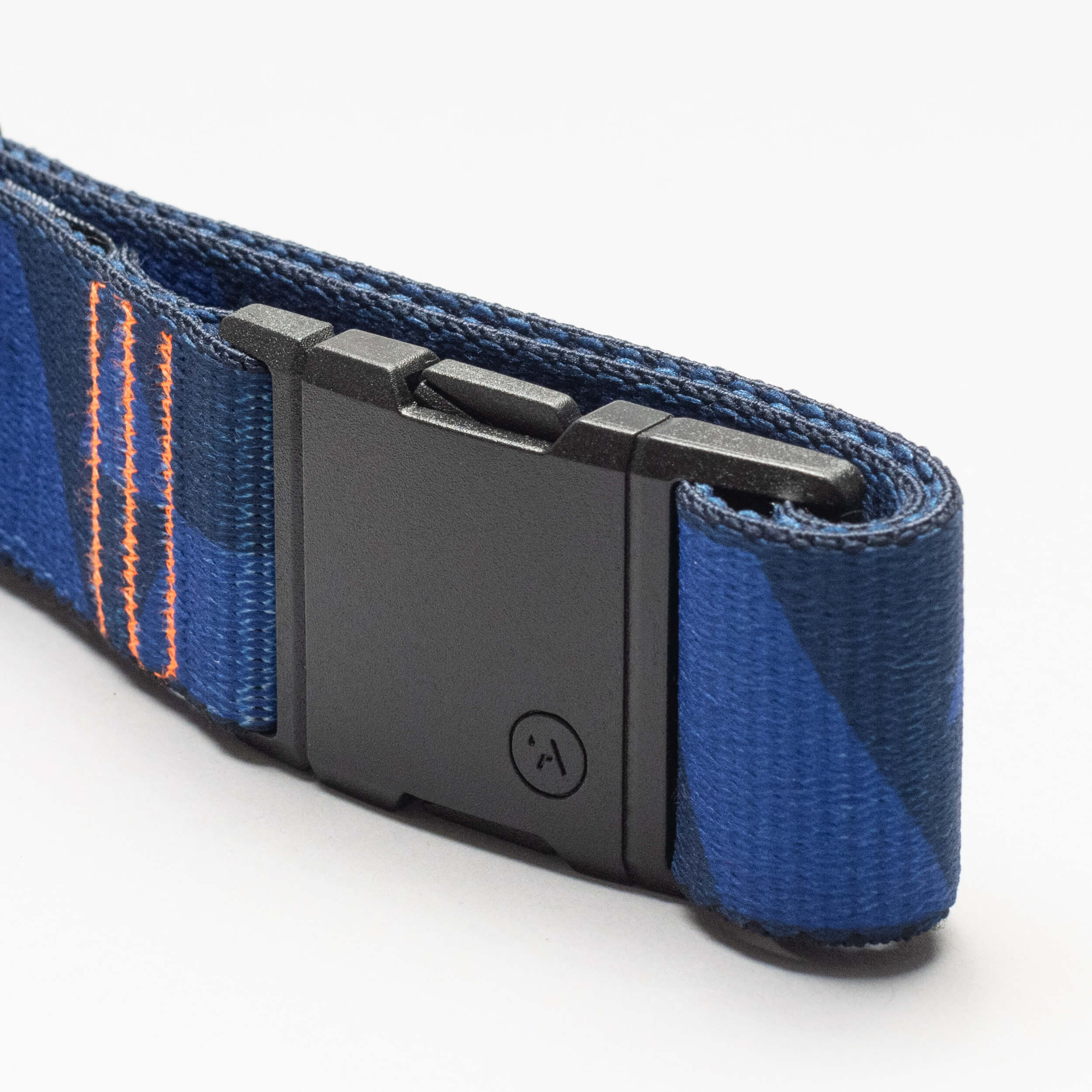 A close-up of the Arcade Belts DDC: a blue woven strap with orange stitching and a black plastic buckle, designed as a low-profile belt, shown against a plain white background.