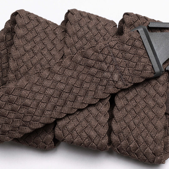 A close-up of the Arcade Belts Futureweave, a brown woven fabric belt with a textured basket-weave pattern and black buckle, shown on a white background.