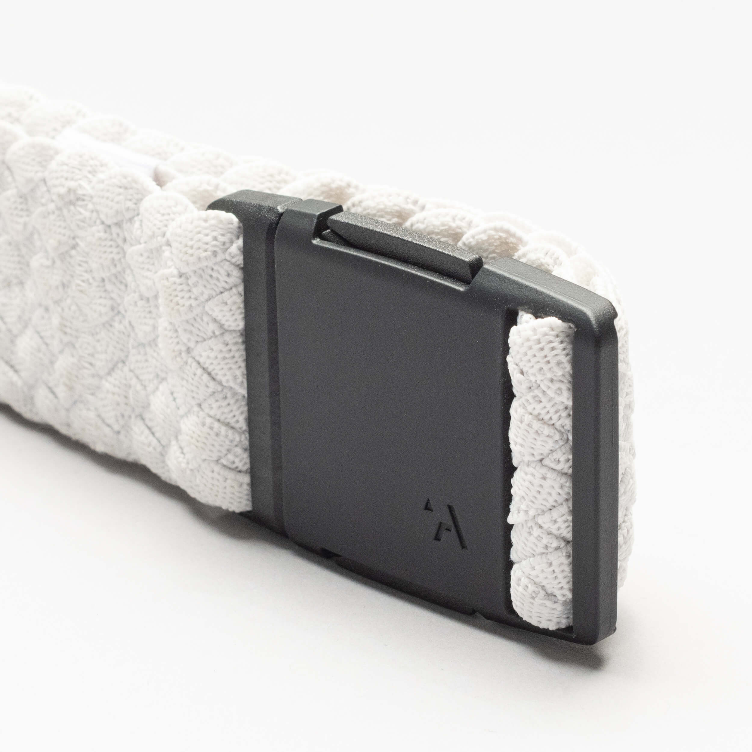 Close-up of the Arcade Belts Futureweave: a textured white, low-profile belt with a matte black plastic buckle, set against a plain white background.