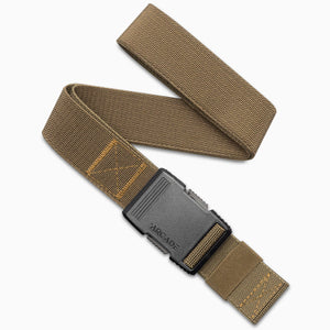 The Arcade Belts Hardware is a brown elastic travel belt with yellow stitching and a black plastic buckle, shown coiled on a white background.