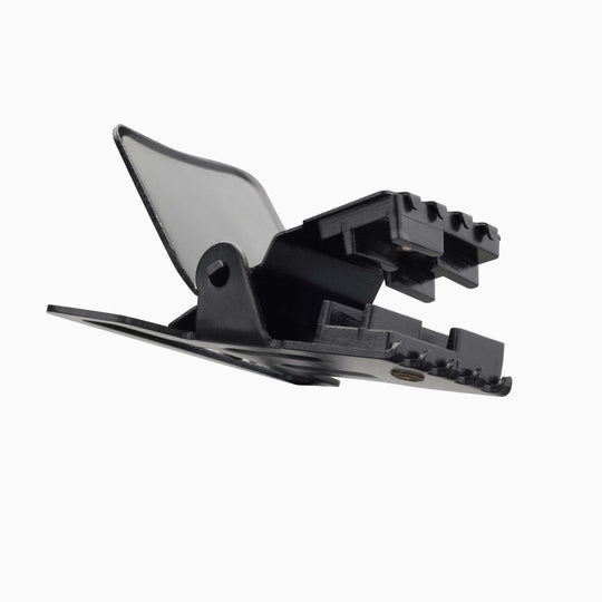 The Jessup hair clip by Arcade Belts features a black plastic design with a spring hinge—shown open against a white background. Pair it easily with your favorite Elastic Stretch Belt or Travel Belts for effortless, on-the-go style.