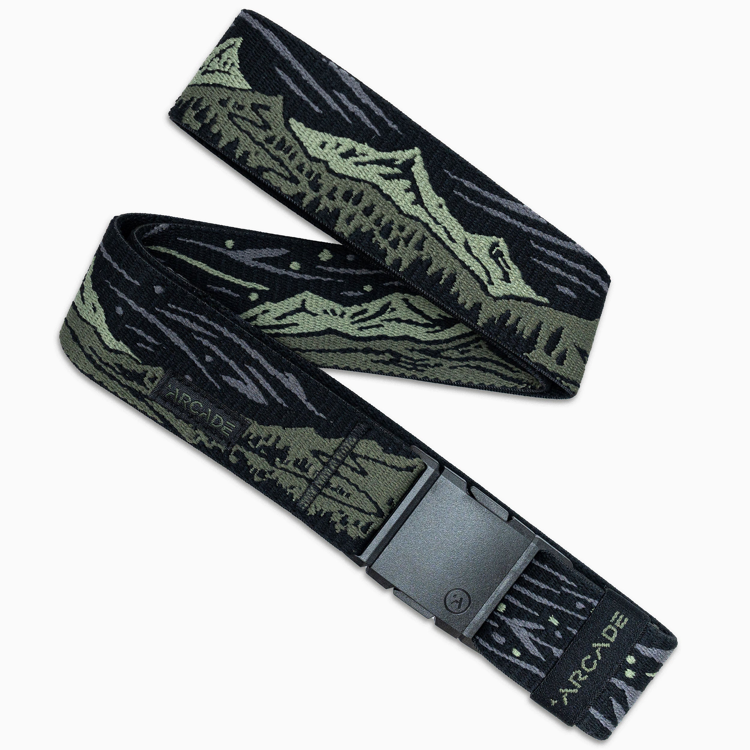 The Arcade Belts Out of Range Kit is a black and green elastic stretch belt featuring an outdoor mountain design, a sturdy plastic buckle, and ARCADE branding near the buckle. The belt is coiled in an S-shape on a white background.