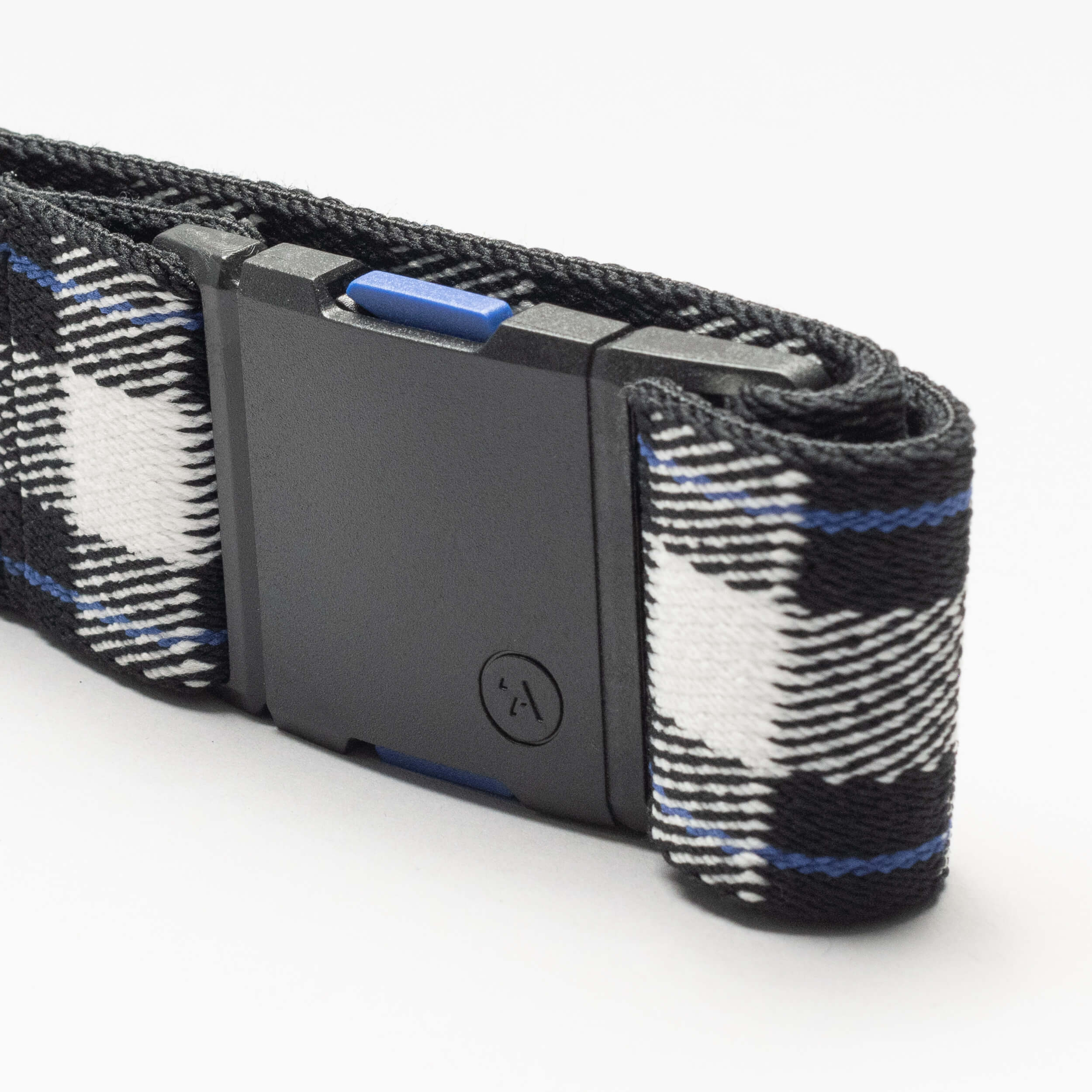 A close-up of the Arcade Belts Plaid—an elastic stretch belt with a black plastic buckle and black, white, and blue plaid pattern—perfect for travel, shown against a white background.