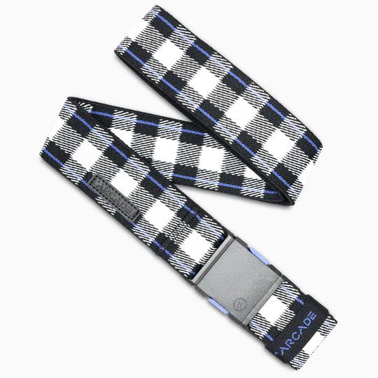 The Arcade Belts Plaid is a black, white, and blue plaid low-profile belt with a rectangular gray plastic buckle and ARCADE printed near the end. The travel belt is shown laid flat in a zigzag shape.