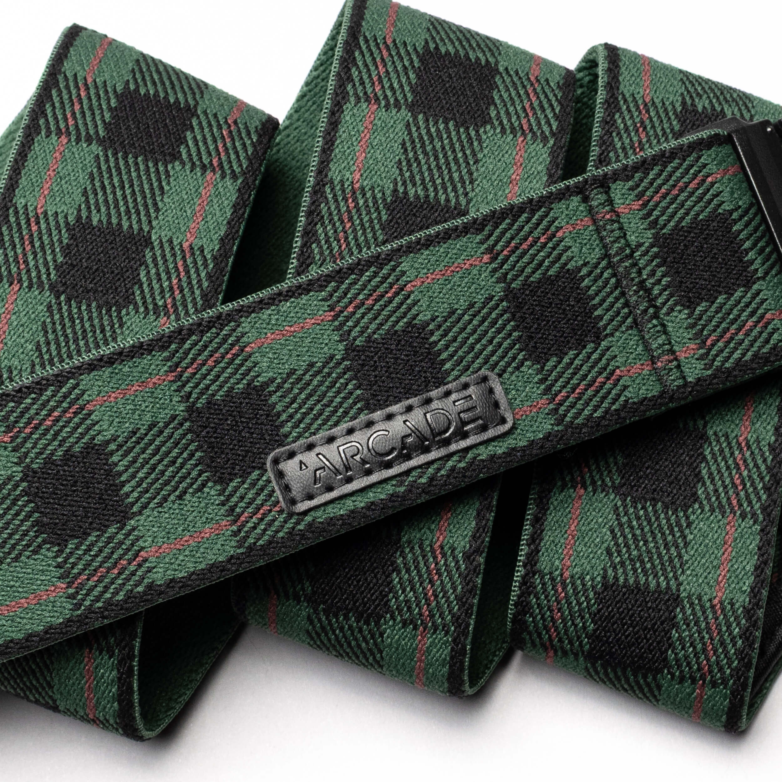 The Arcade Belts Plaid is a green and black stretch webbing belt featuring a low-profile design and a durable plastic buckle.