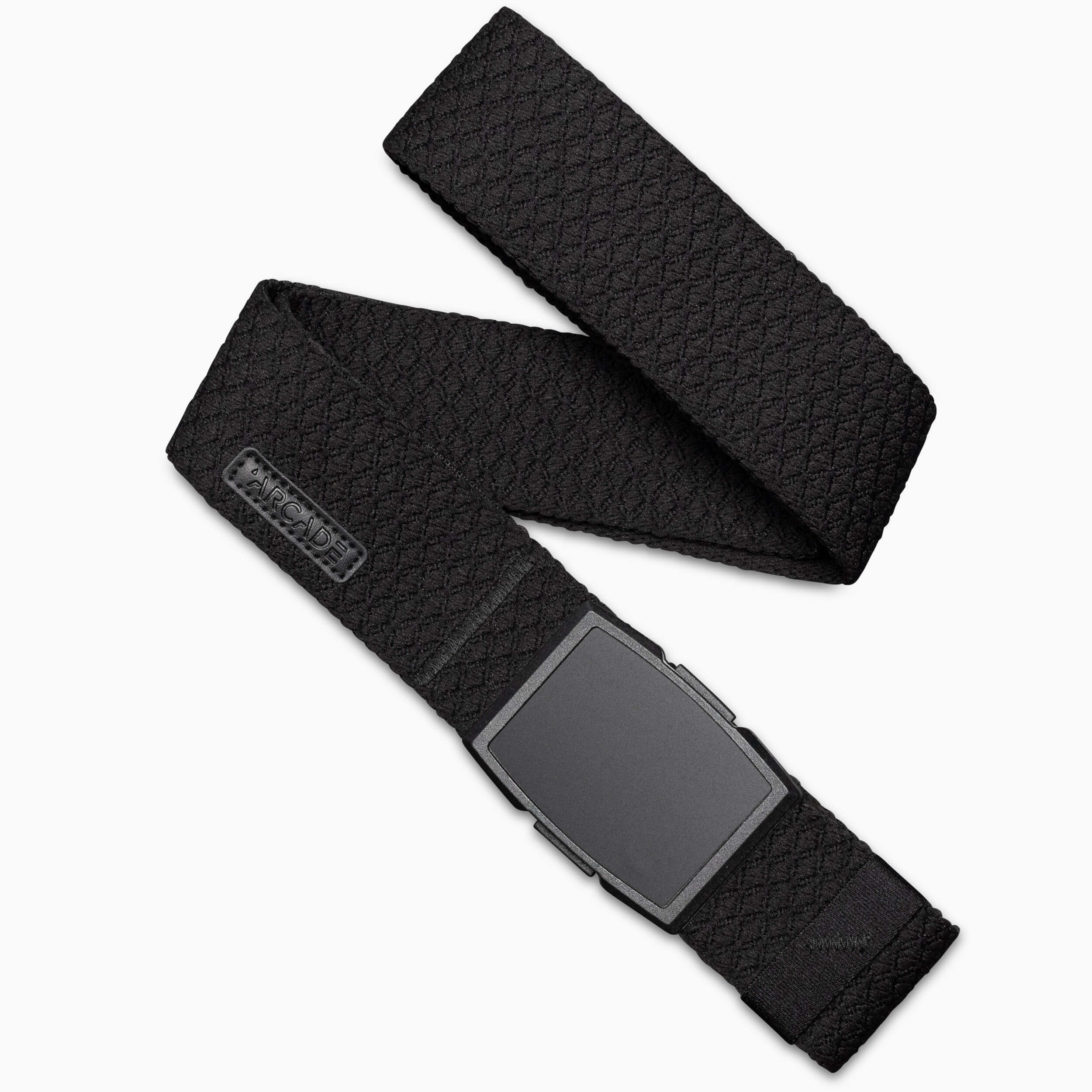 The Salient belt by Arcade Belts is shown against a white background. It features black, diamond-patterned elastic webbing, a stitched rectangular brand label near the matte black rectangular buckle, and a textured design.
