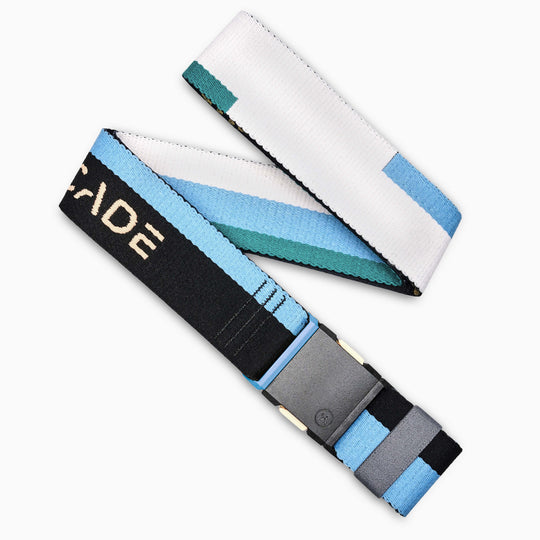 The Arcade Belts Sierra is a woven stretch webbing belt in black, white, blue, and teal patterns with a gray plastic buckle and partial CADE on one end, displayed in a loose zigzag shape.